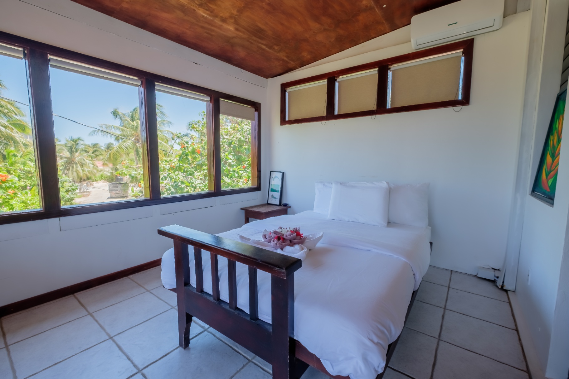 Bedroom with wraparound windows over the gardens