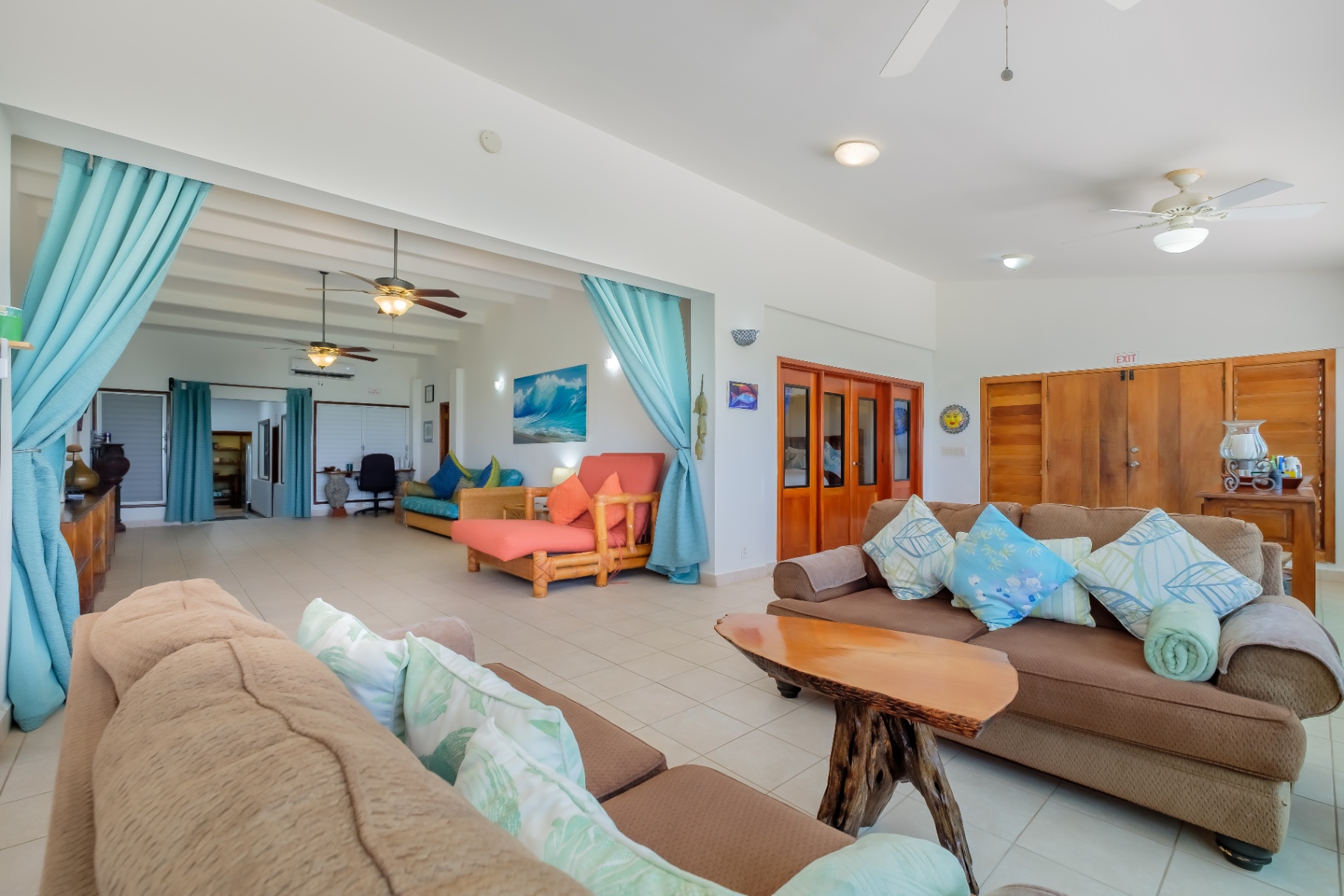 Open great room with sofas and ocean light