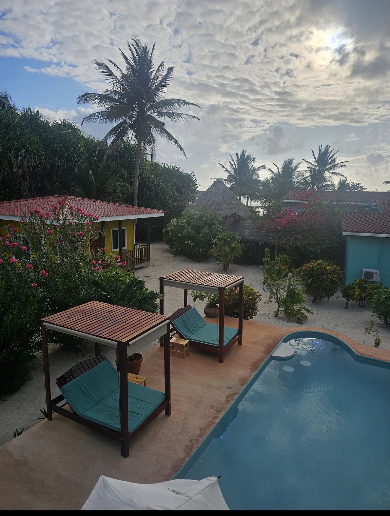 Pool and courtyard at Playa Blanca Island Villas framed by palms and colorful villas