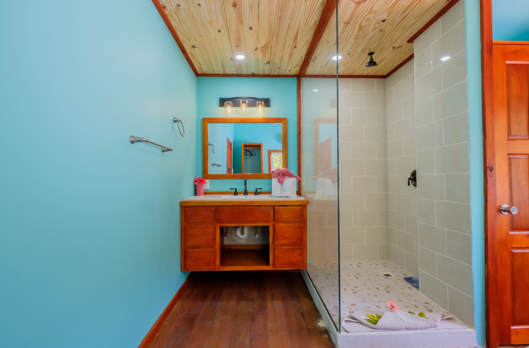 Bright blue bathroom with walk-in glass shower