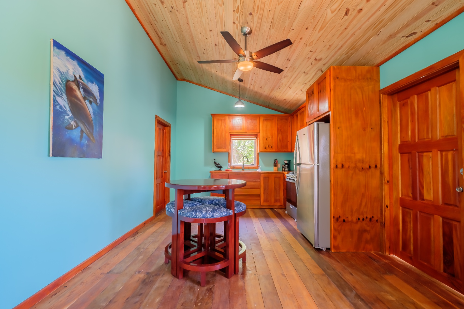 Studio kitchen with dolphin painting and vaulted ceiling