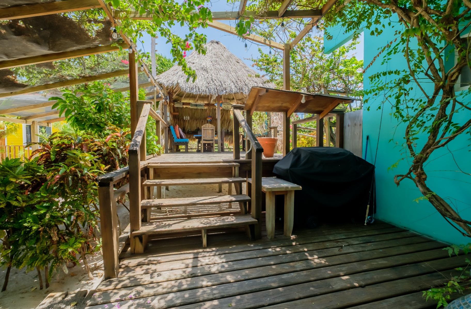Wooden deck steps leading to the palapa & BBQ