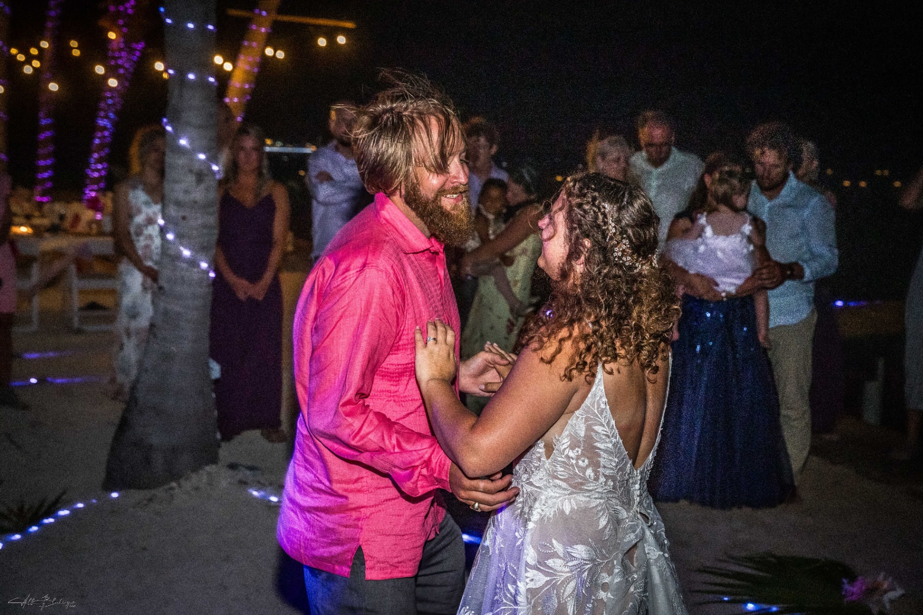 Bride and groom sharing their first dance at a beach reception