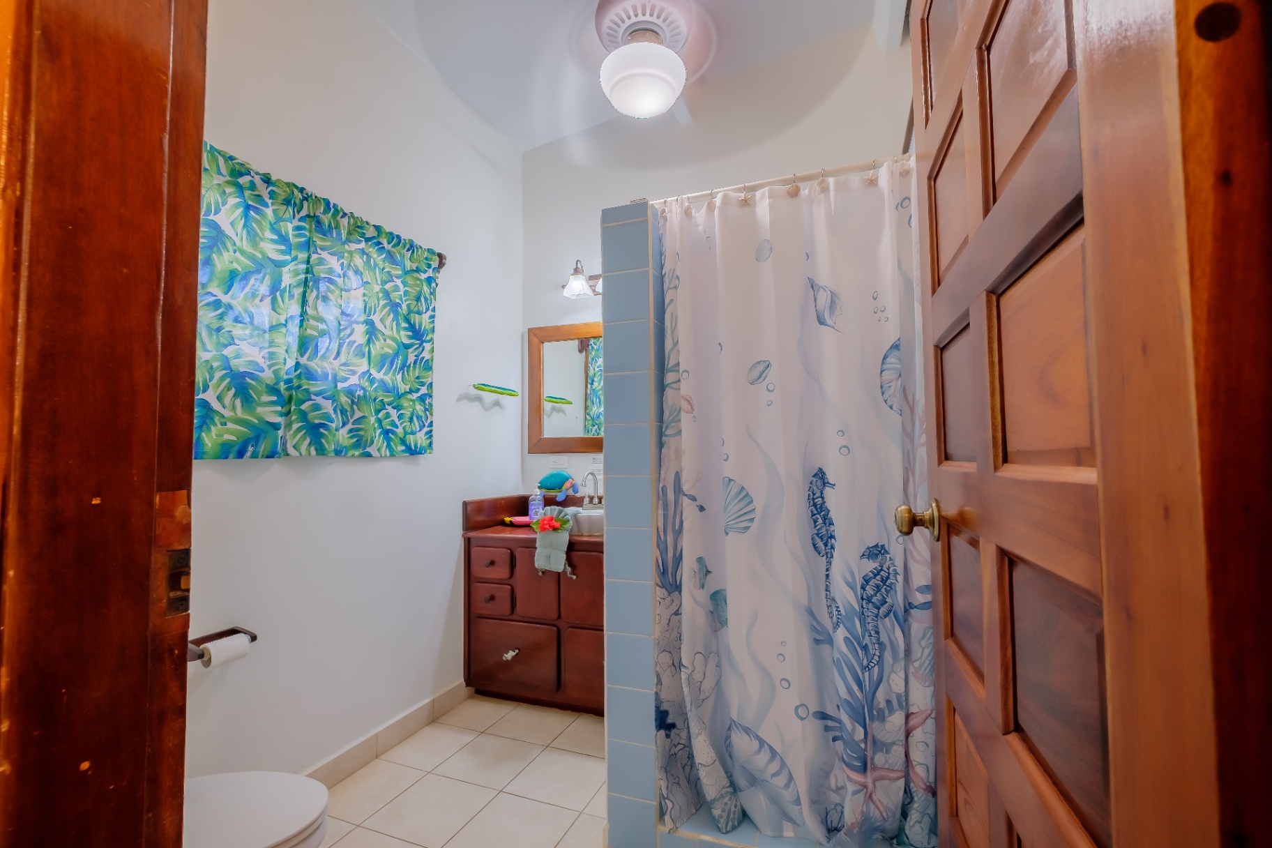 Guest bathroom with palm-print and reef decor