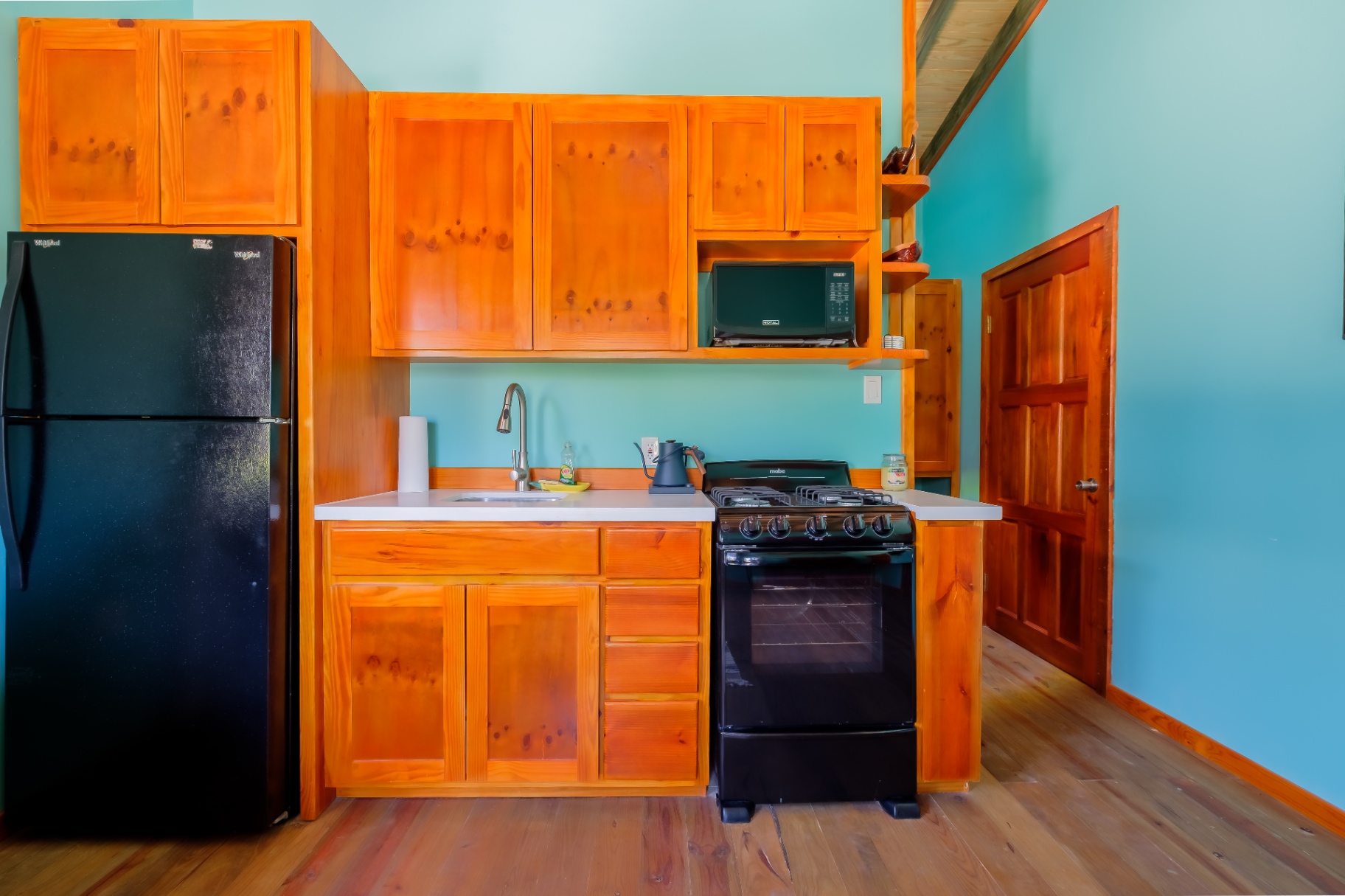 Pine kitchen with white quartz counters and gas range