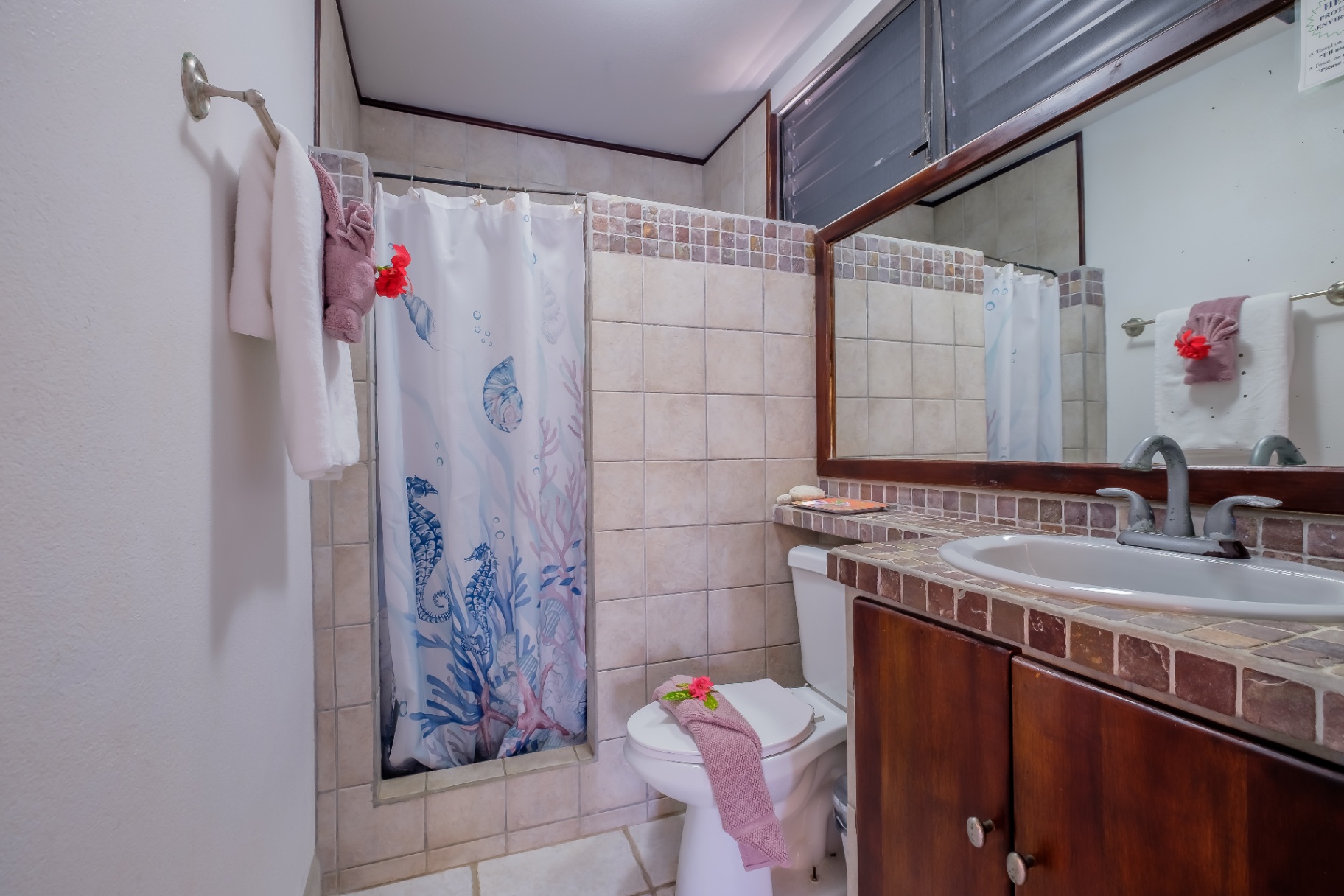Second bathroom with seahorse curtain and stone tile