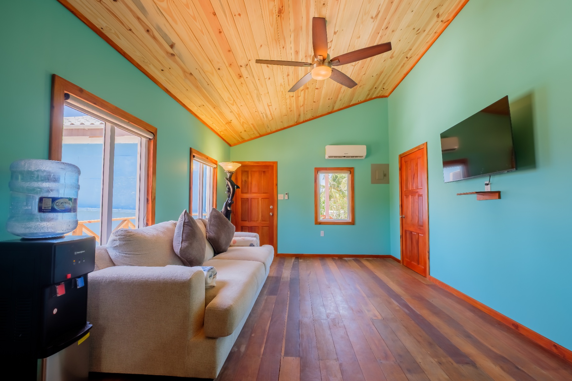 Teal living room with sliding doors to the deck