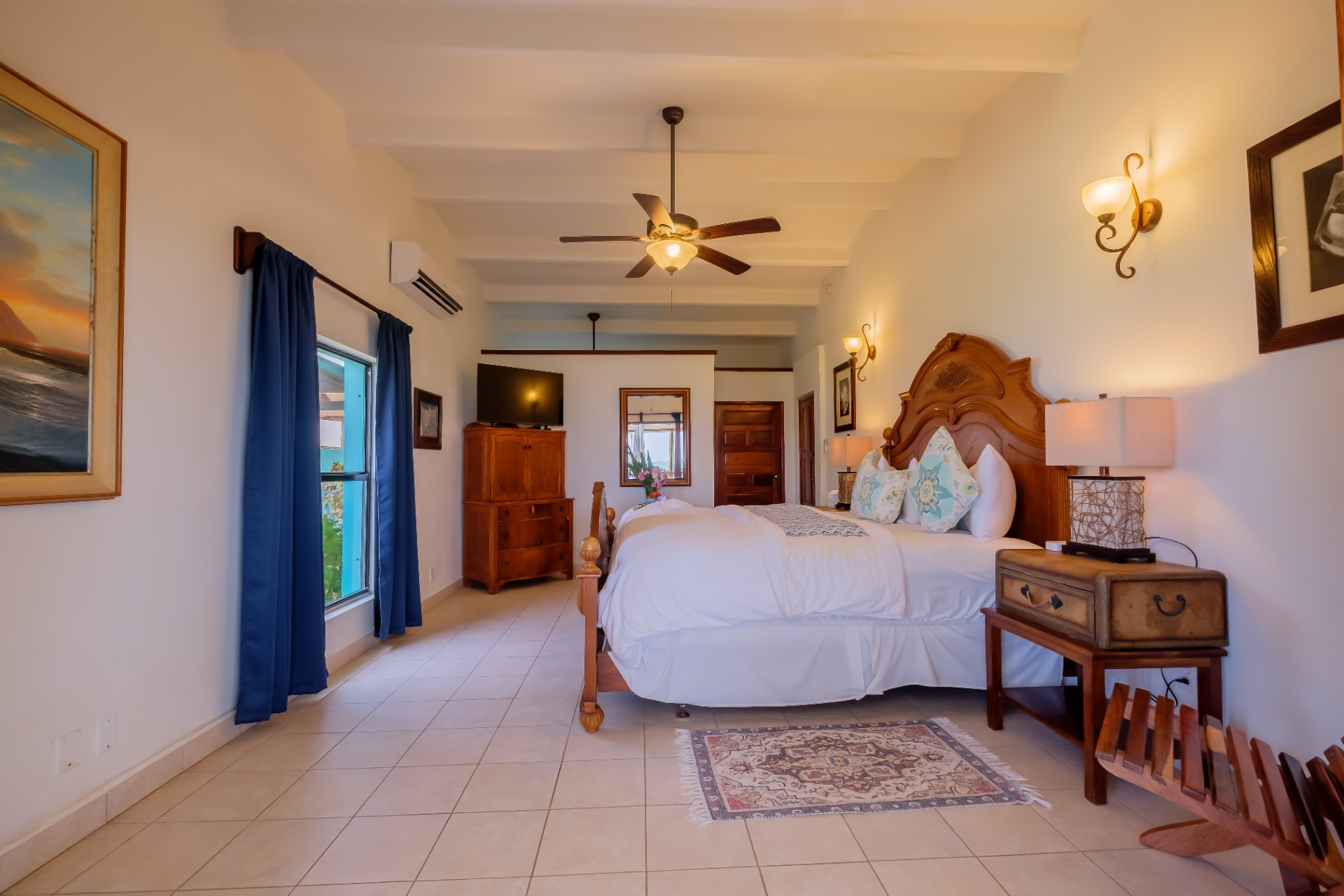 Second king bedroom with art and TV
