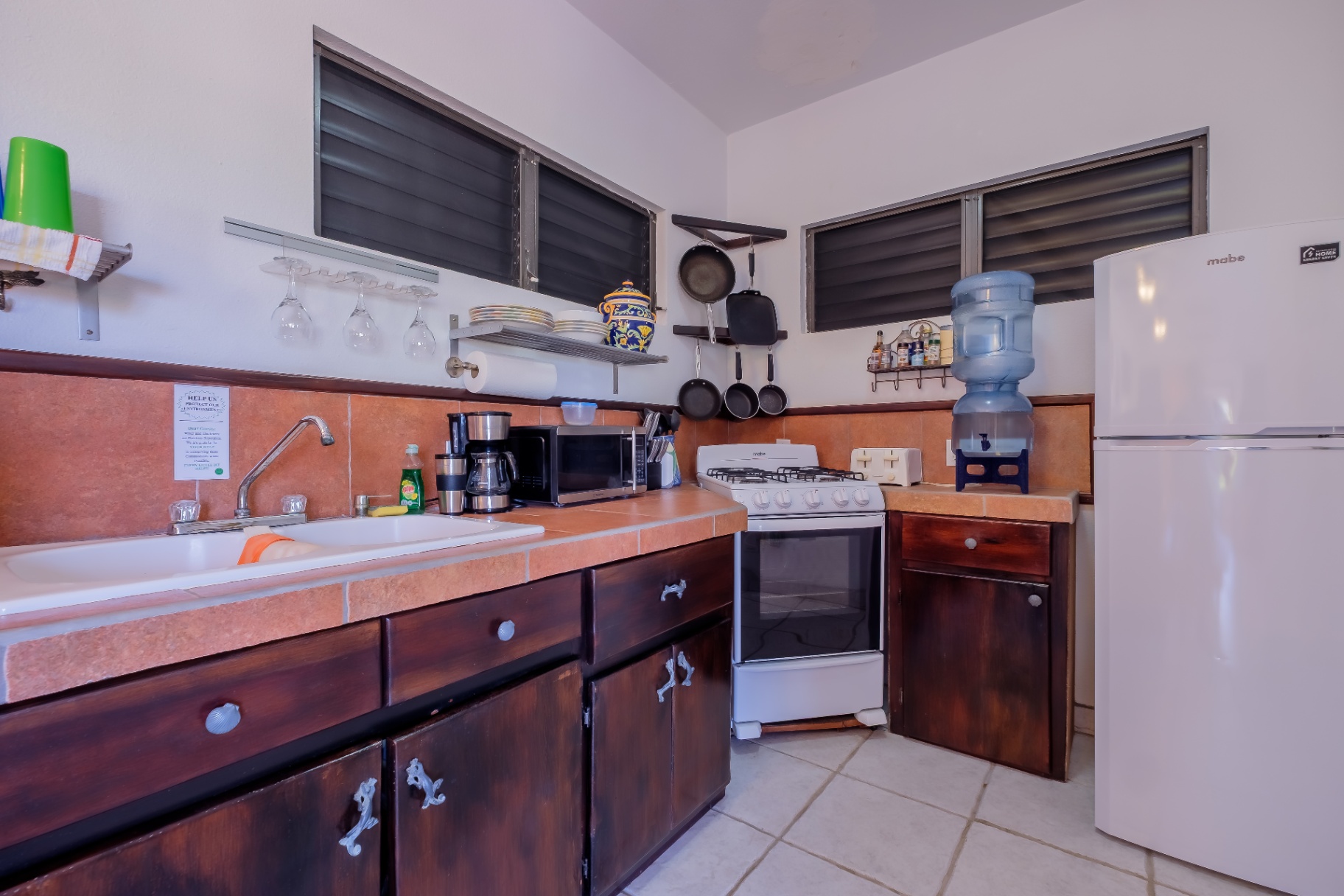 Studio kitchenette with gas range and hanging cookware