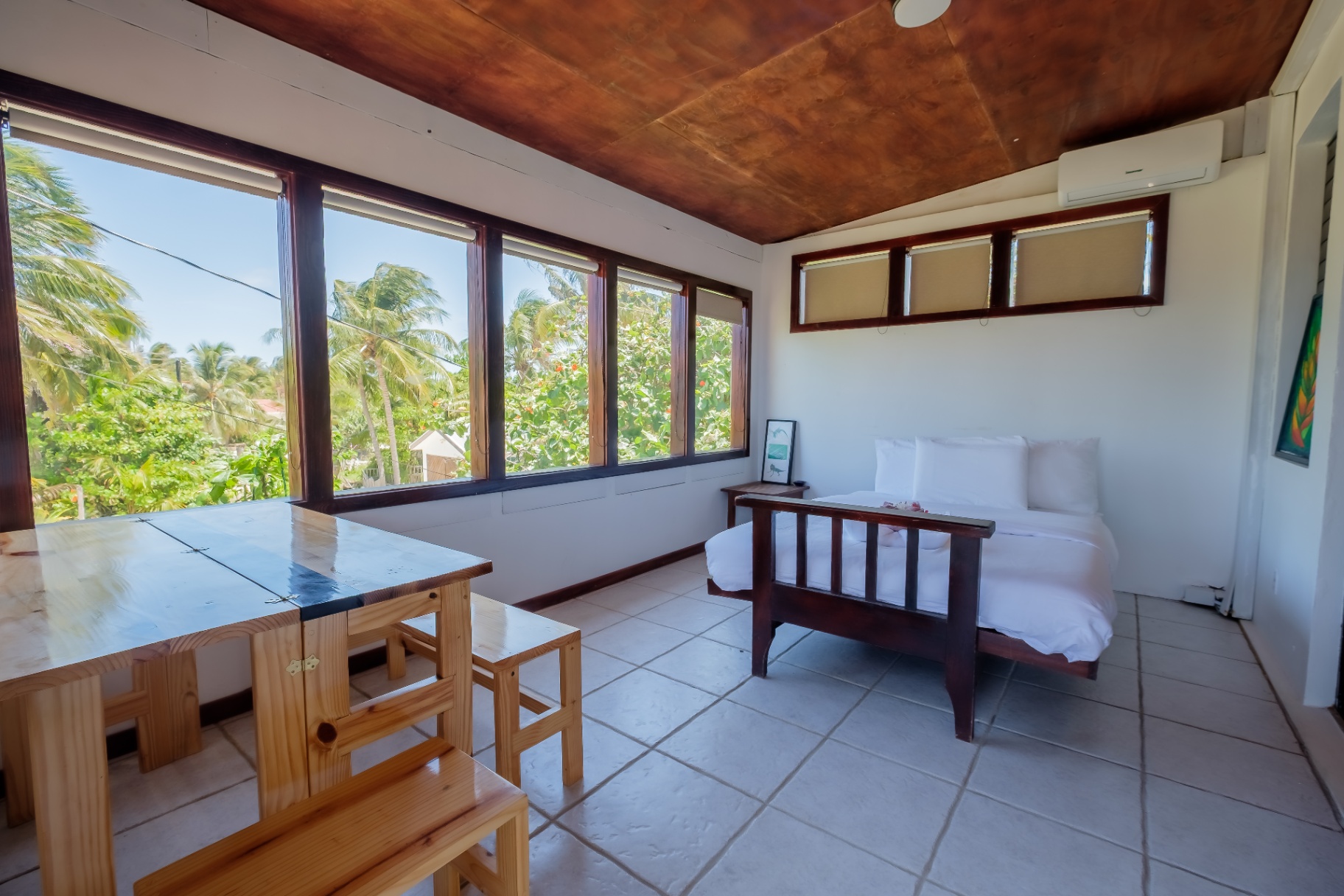 Sunroom daybed with palm-framed island views