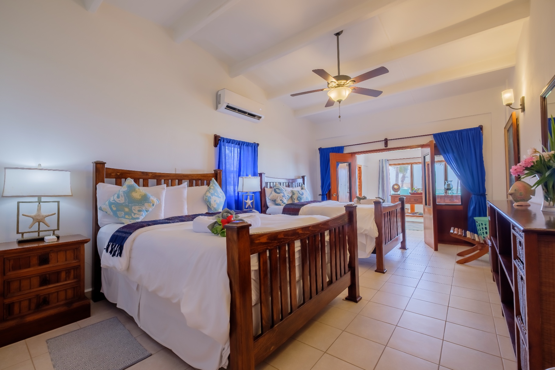 King and twin bed suite with blue curtains