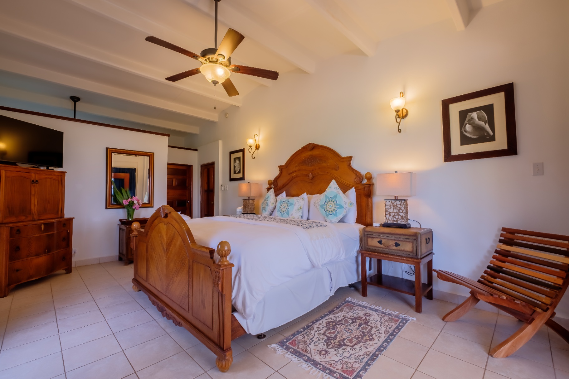 Primary king bedroom with carved wood bed