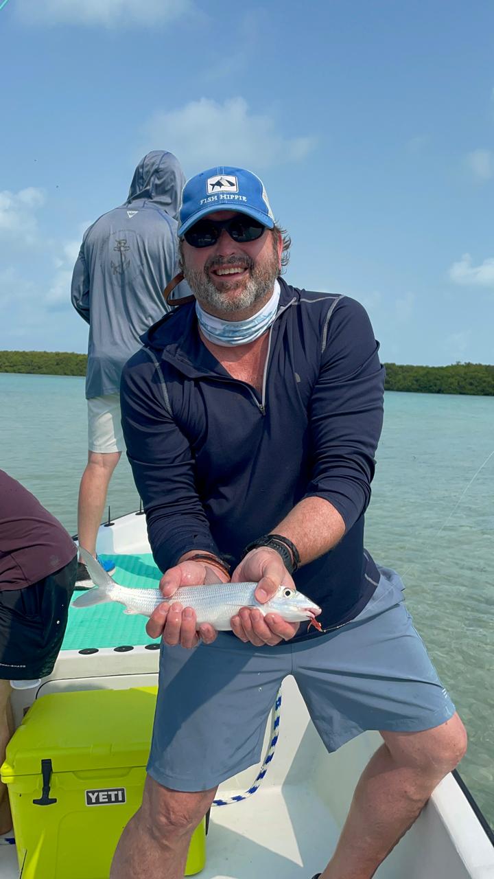 Guest with a bonefish boatside in the mangrove channels