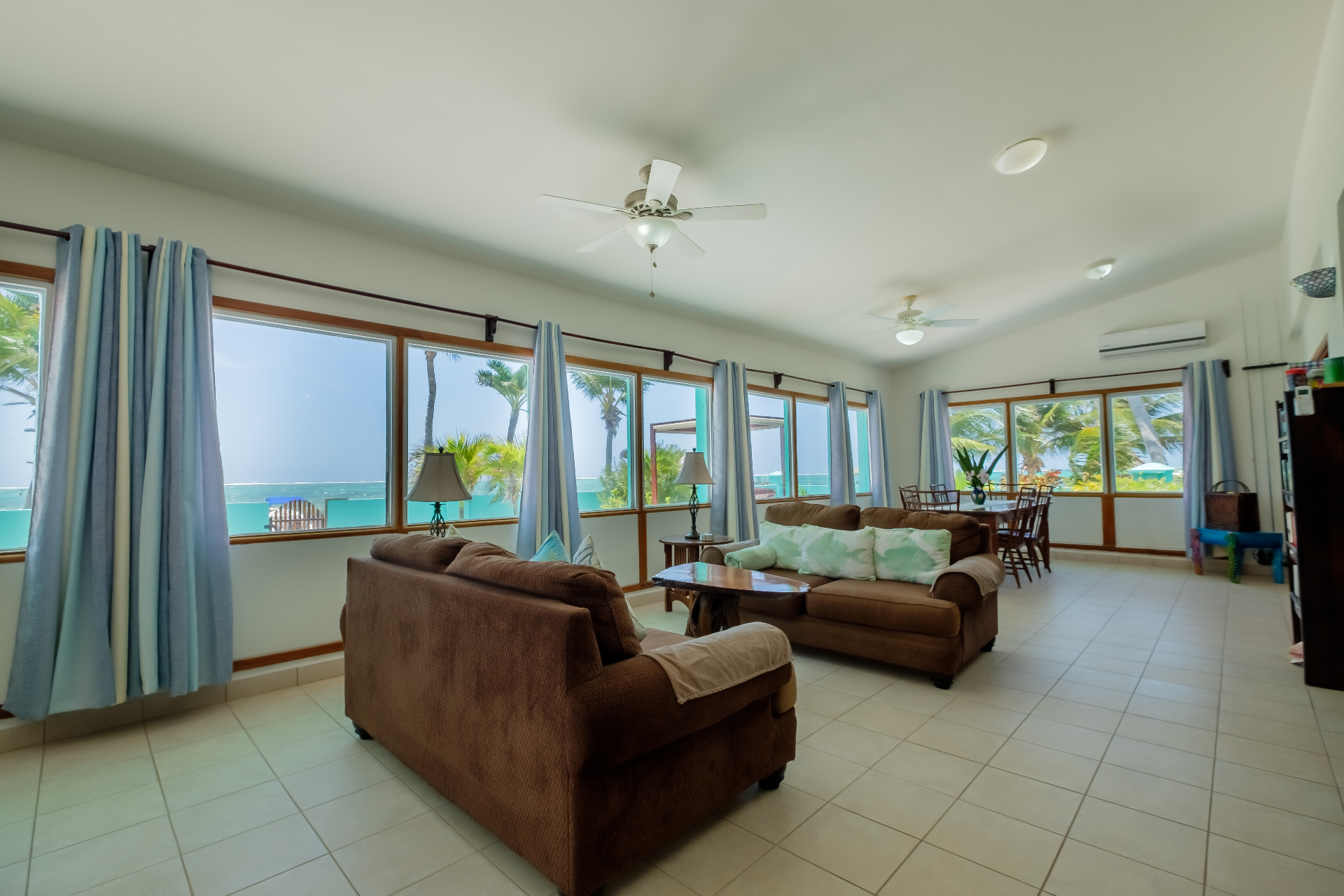 Beachfront lounge seating with dining area beyond