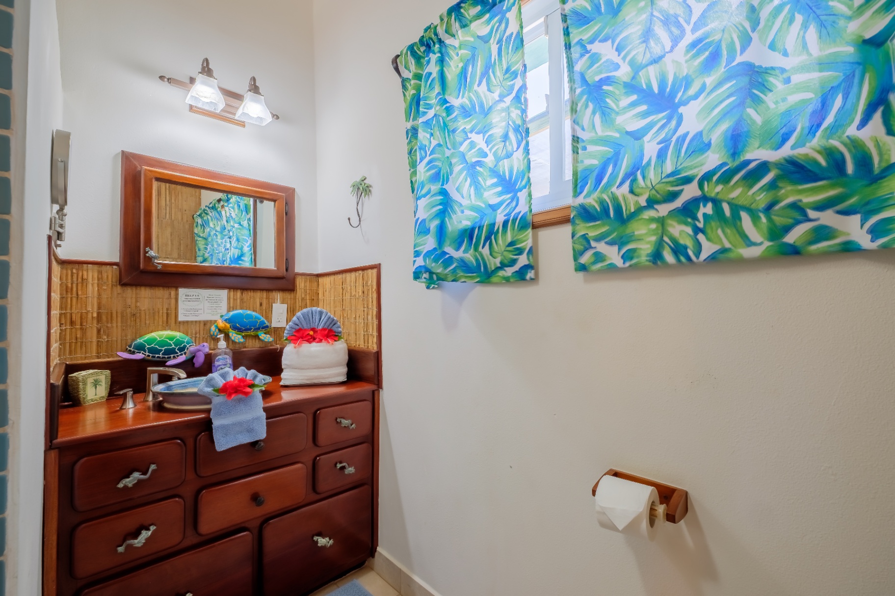 Powder room with tropical palm-print curtains