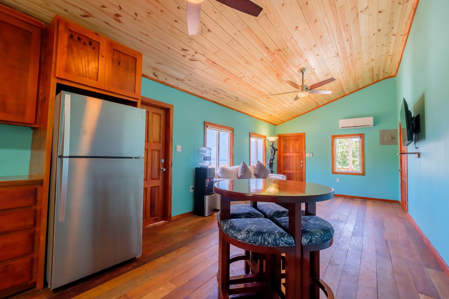 Studio dining nook with hardwood floors and tropical light
