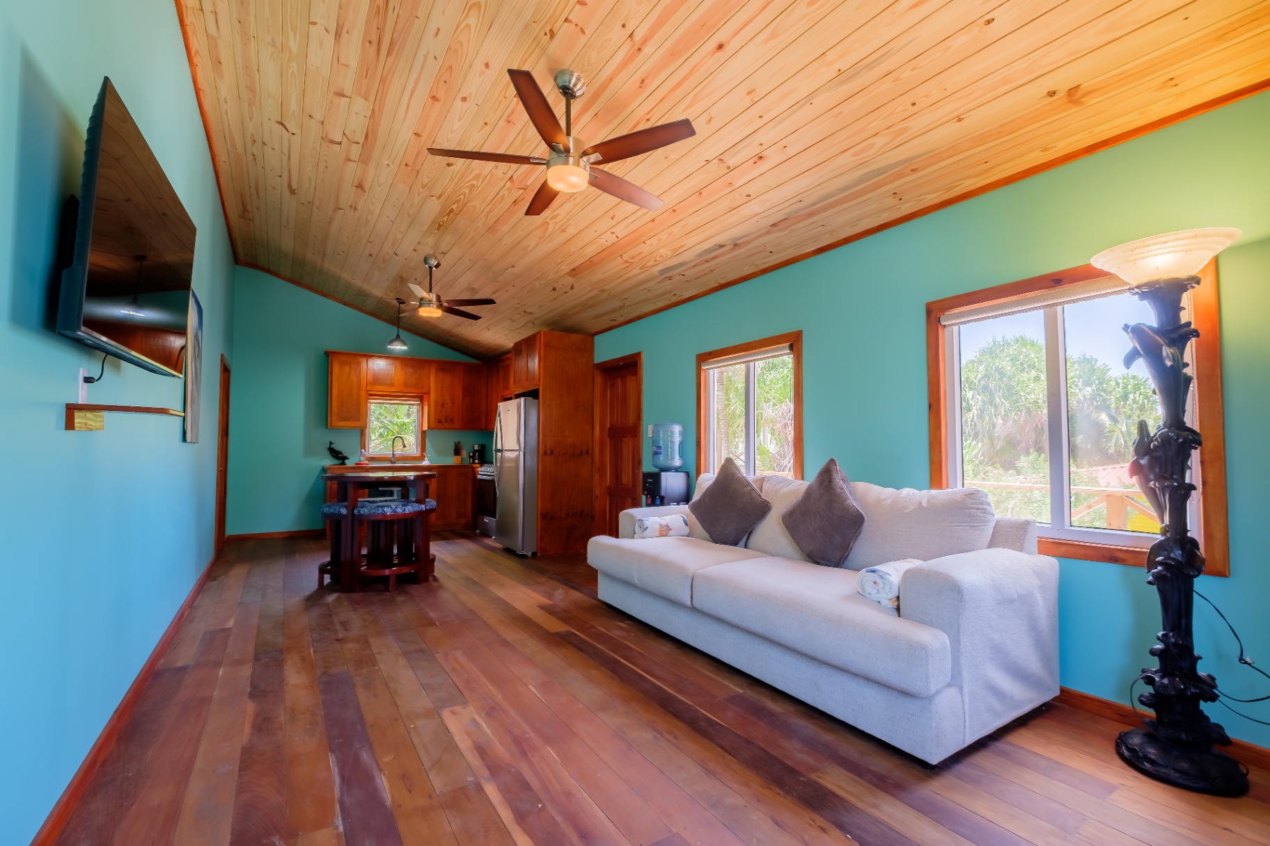 Open great room with vaulted pine ceiling and hardwood floors