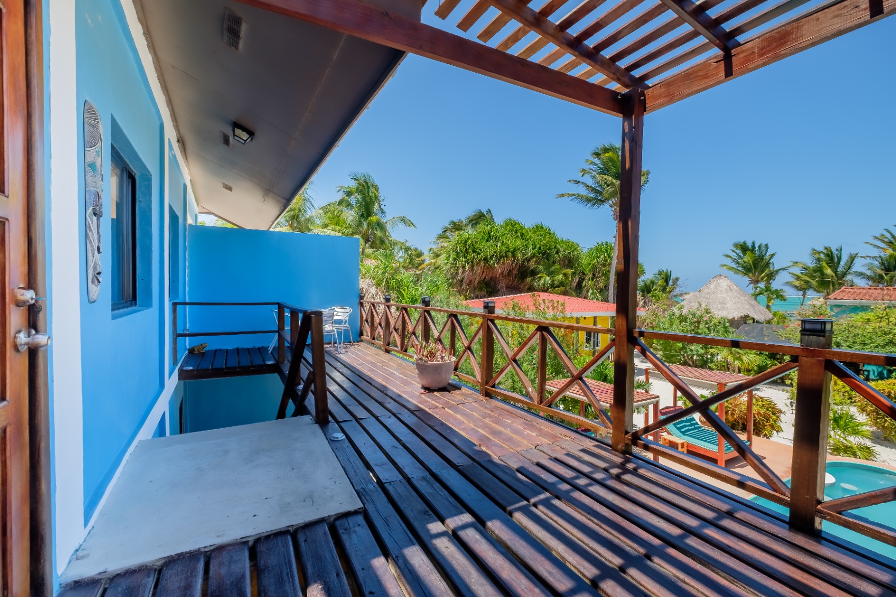Balcony view across palms toward the Caribbean