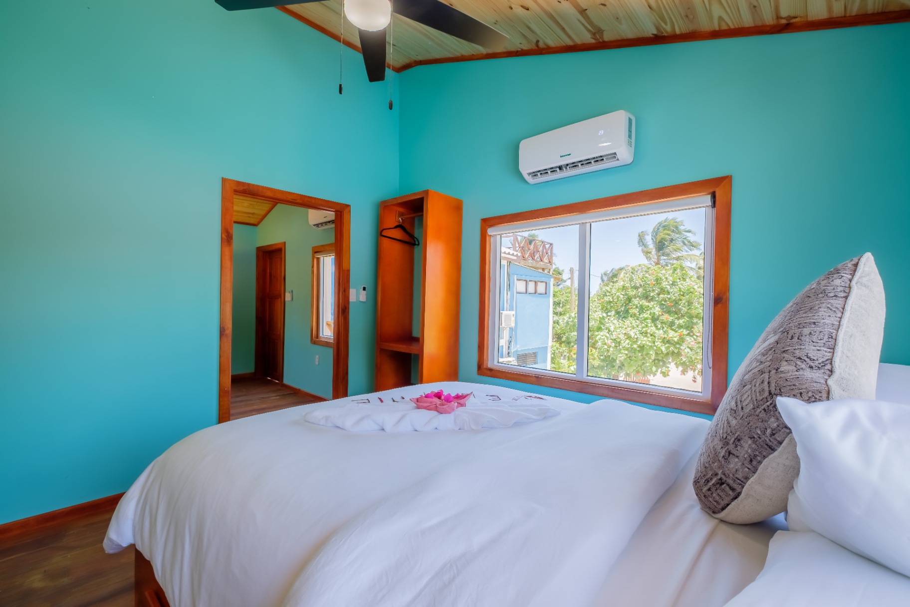 King bedroom in turquoise with vaulted pine ceiling