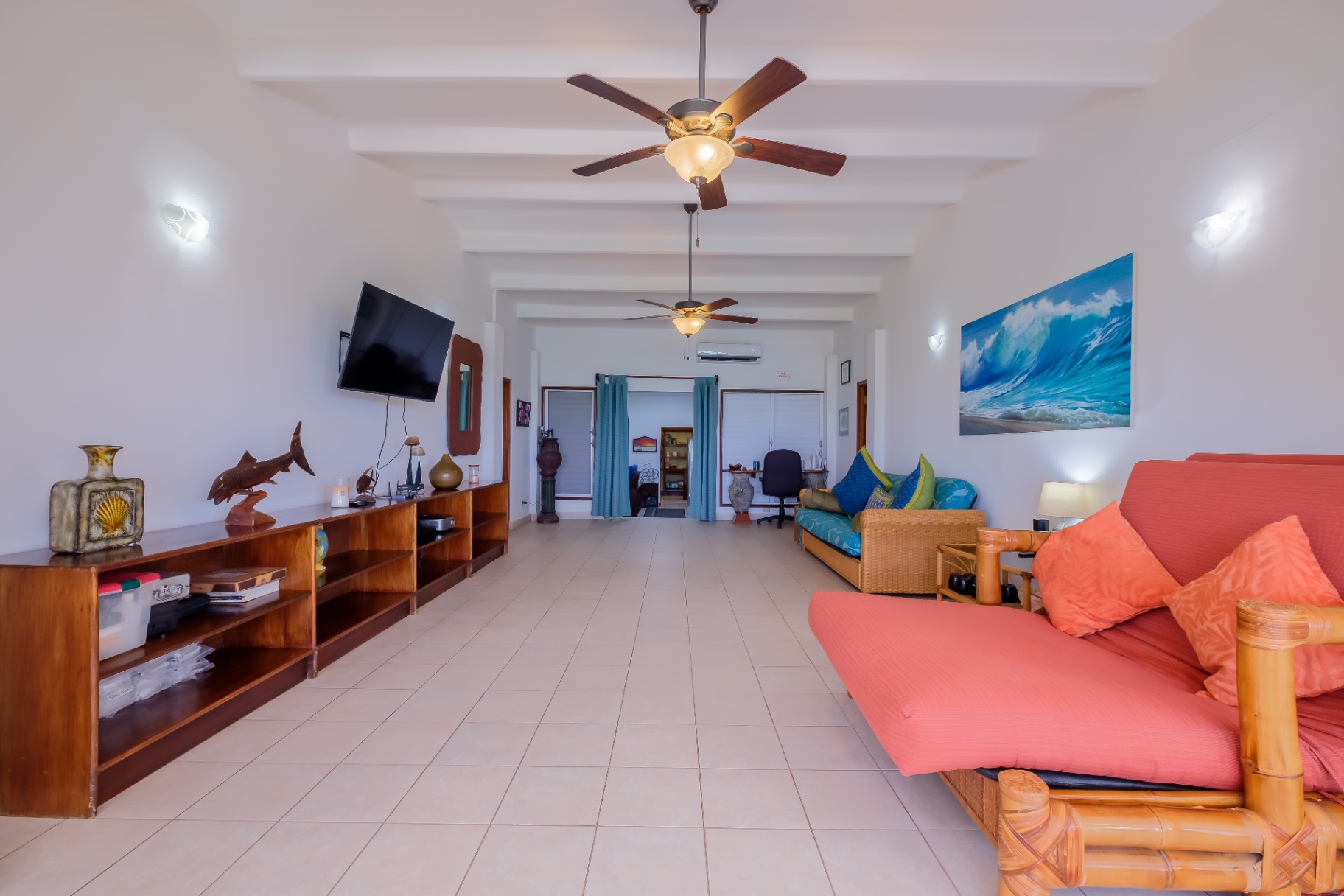 Living room with bamboo futons and ocean artwork