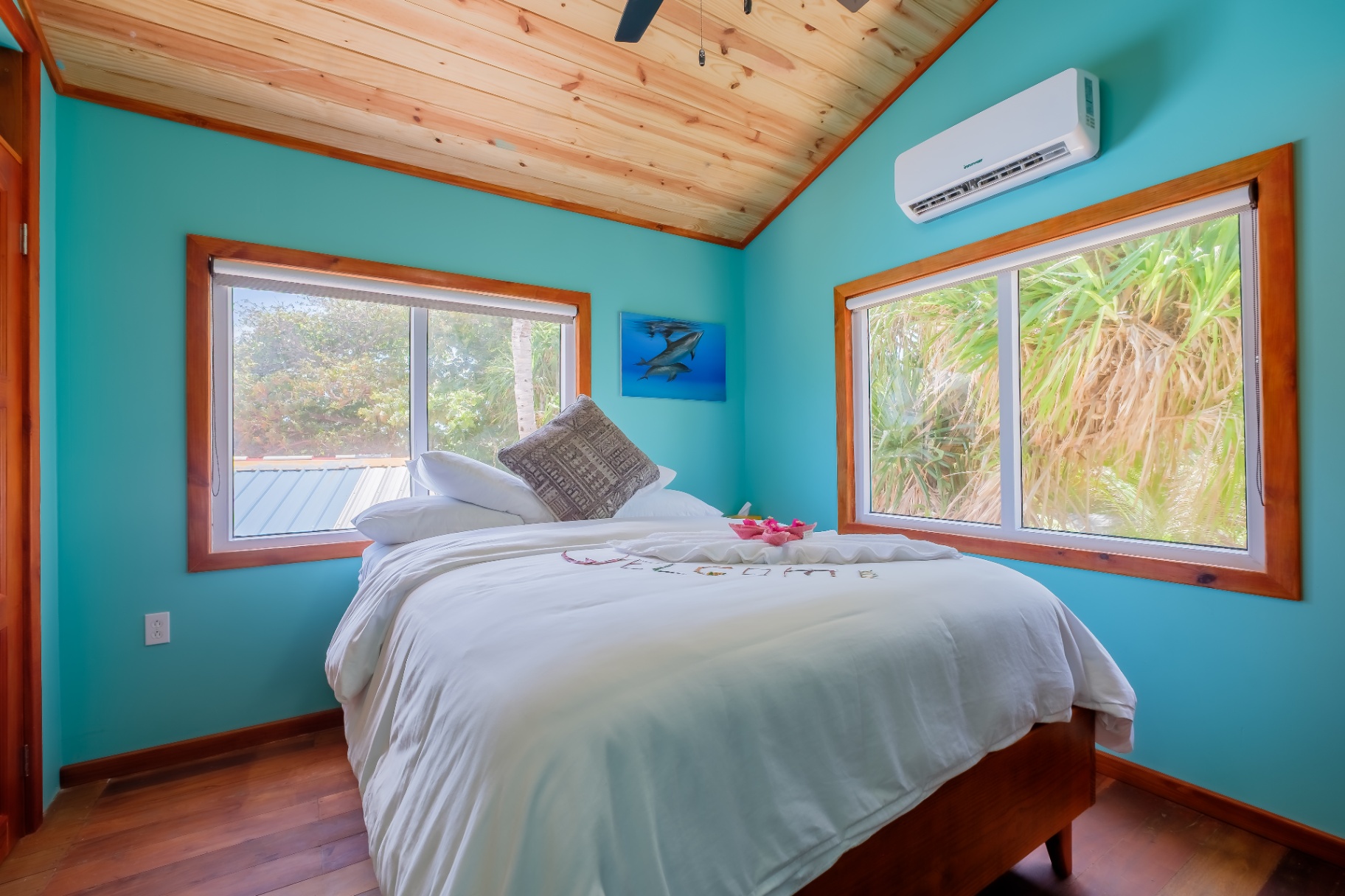 Studio queen bedroom in turquoise with pine ceiling