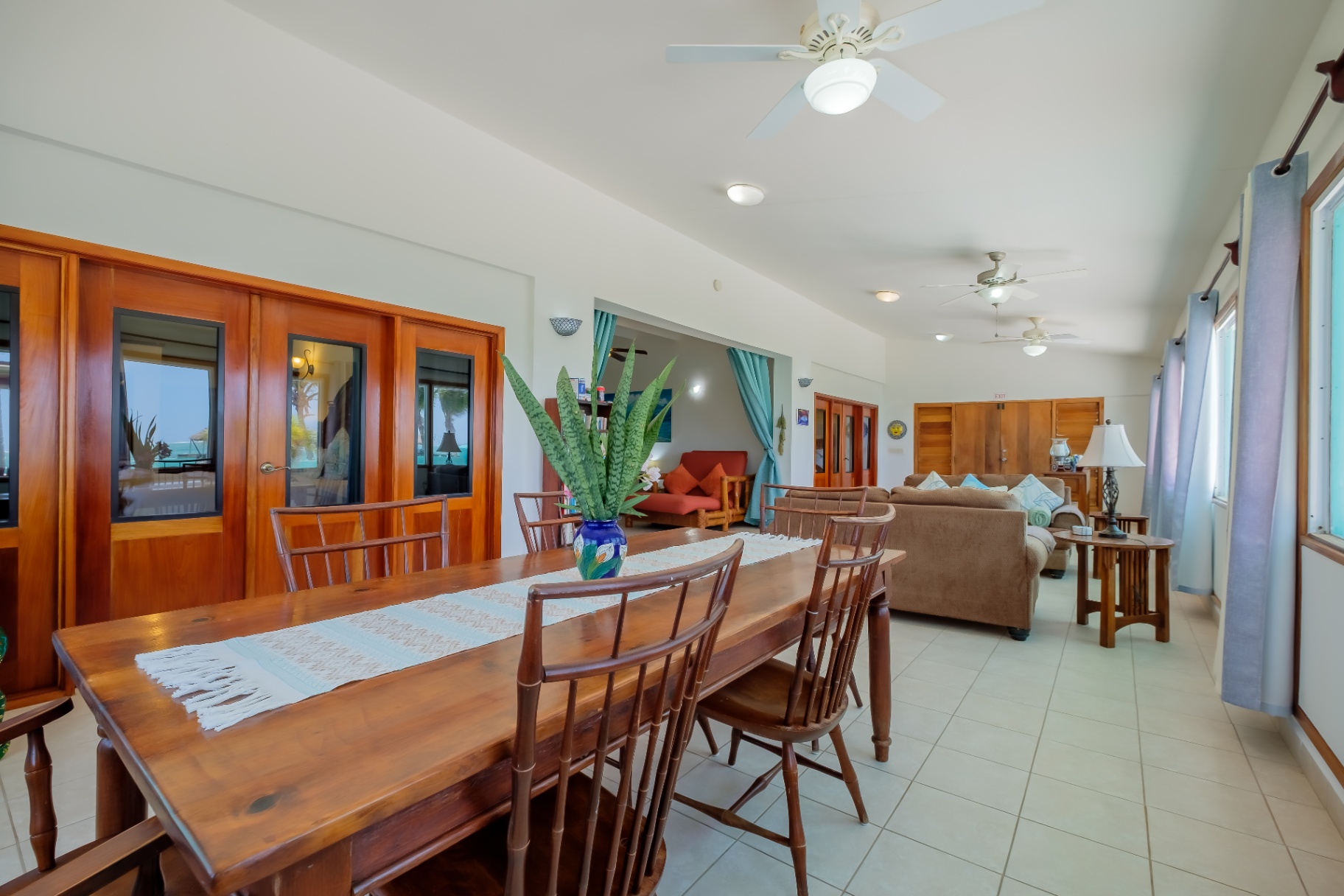 Great room with long mahogany dining table and lounge