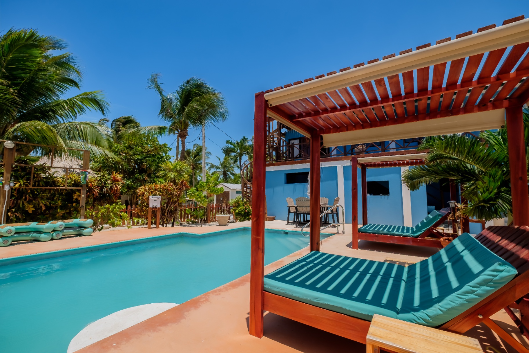 Poolside cabana daybeds beside the Birds Nest