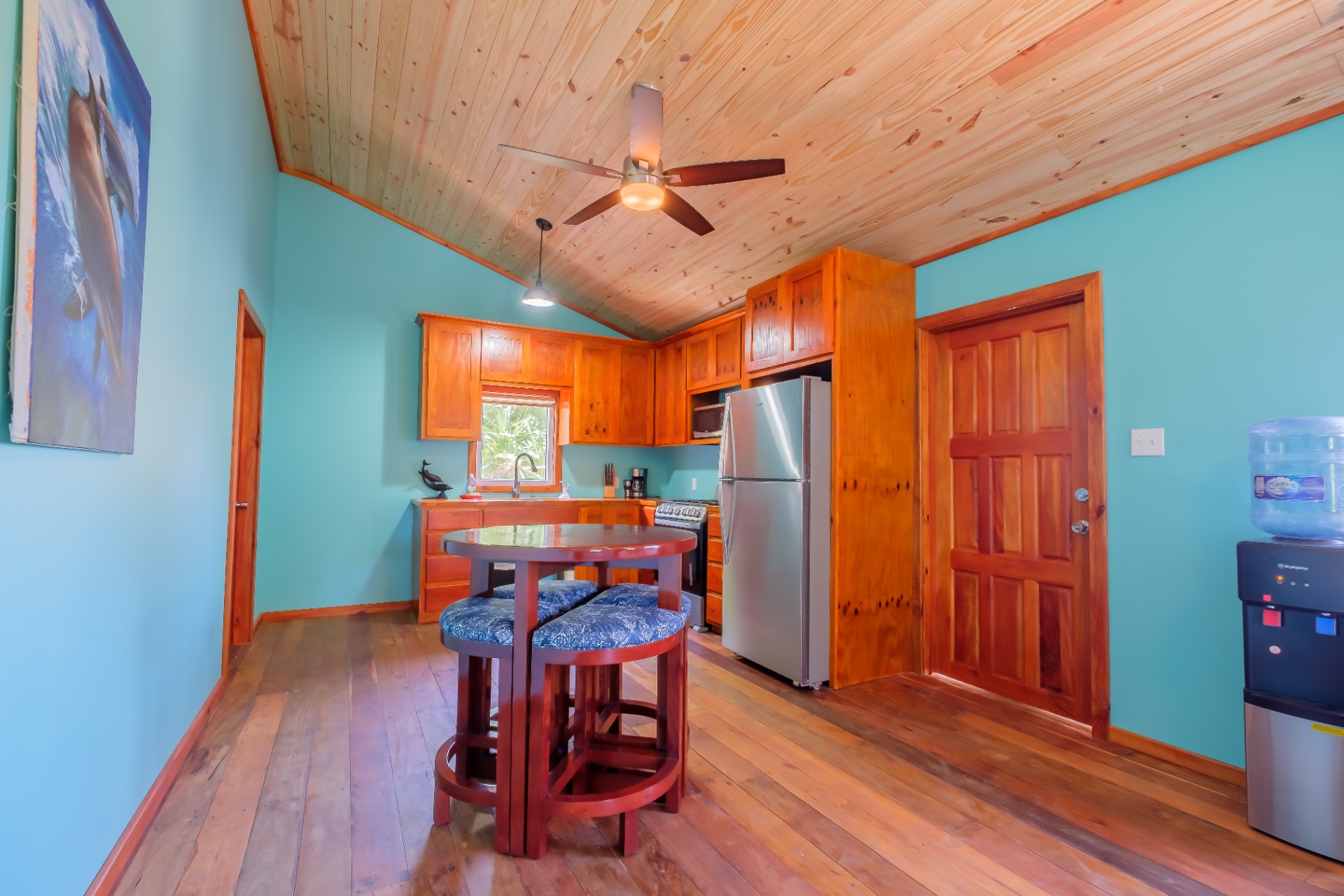 Dining nook beside the kitchen with dolphin artwork