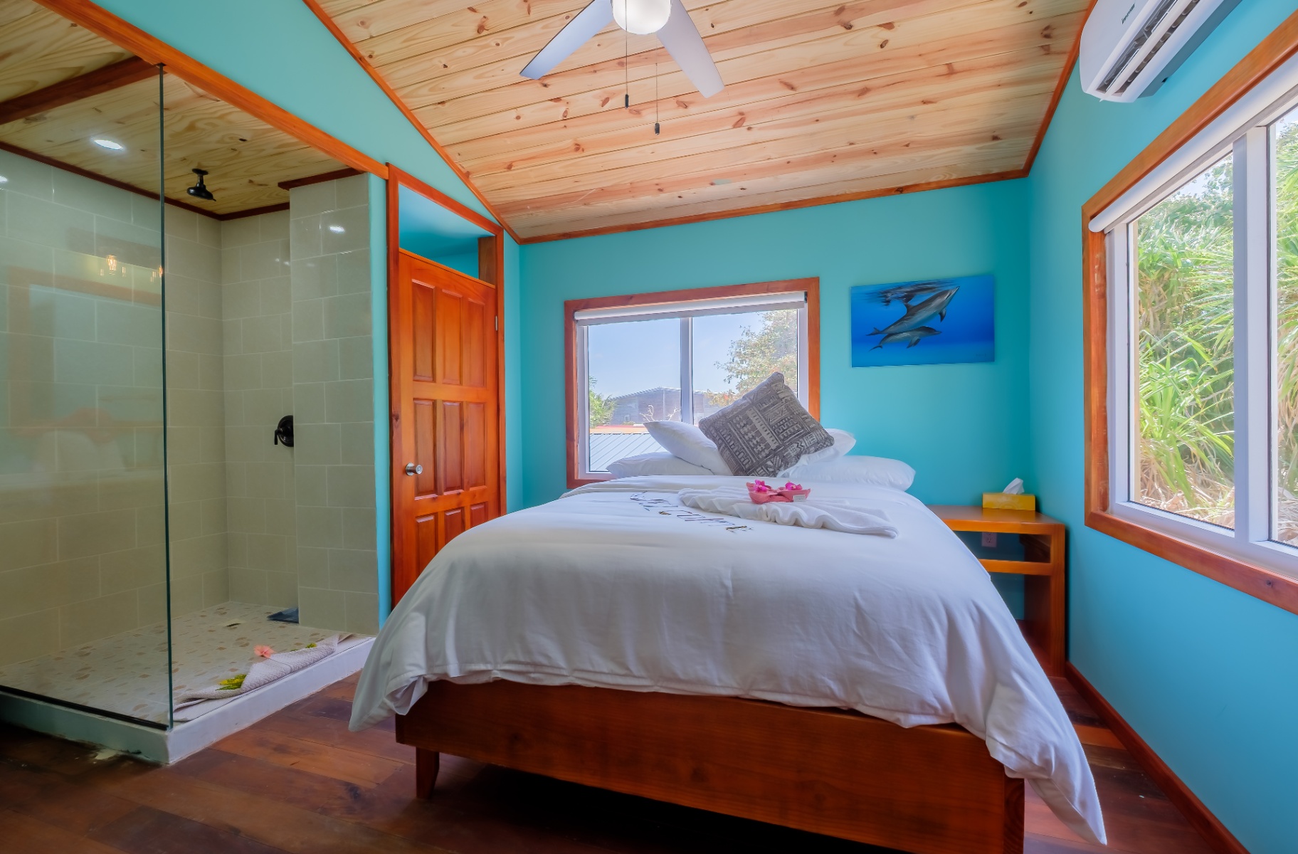 Queen bedroom with dolphin canvas and walk-in shower