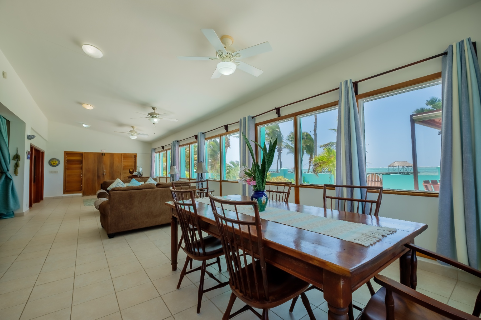 Dining table and living room with reef-facing windows