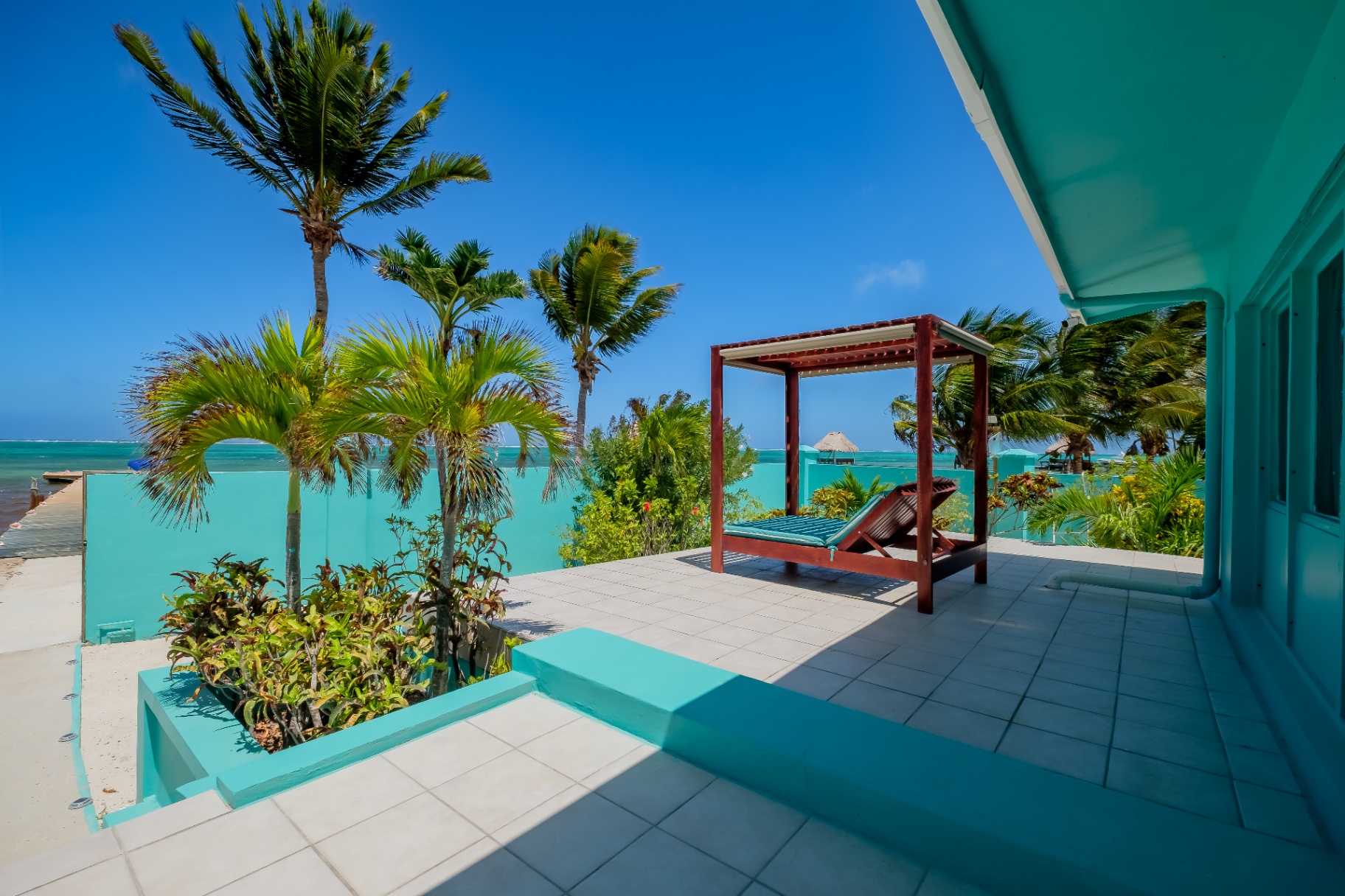 Covered patio daybed with reef and dock view