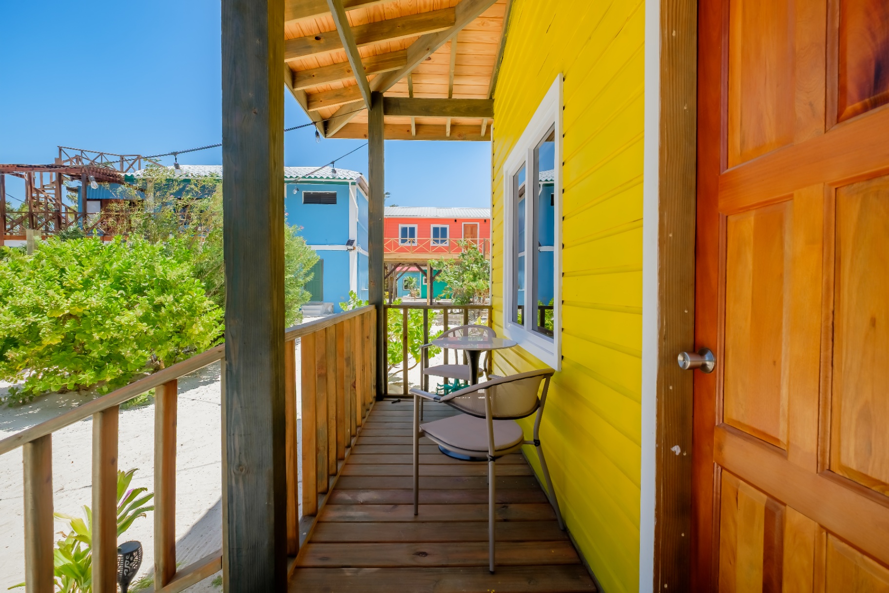 Private covered porch with bistro seating and ocean breeze