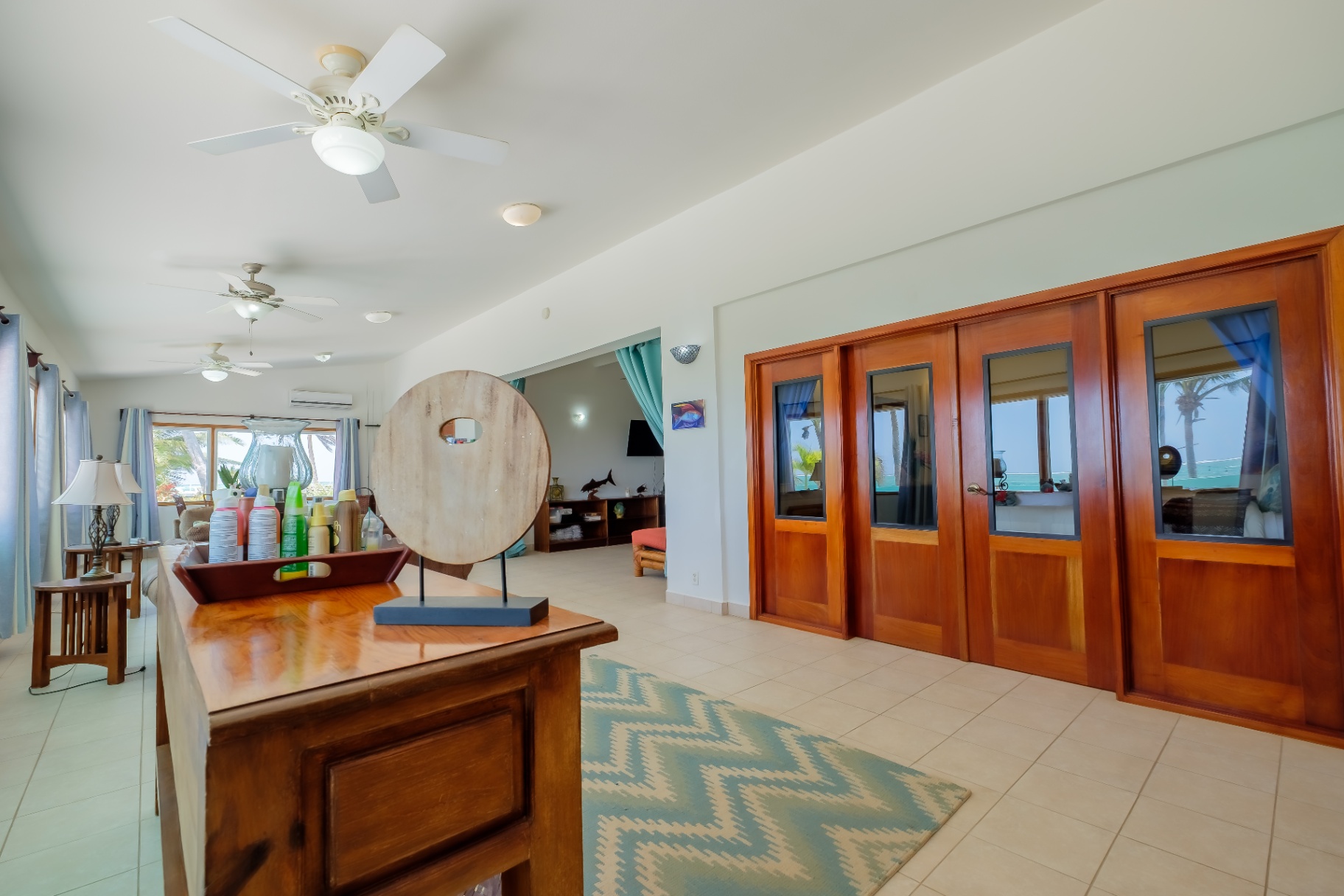 Mahogany French doors opening to the sea terrace