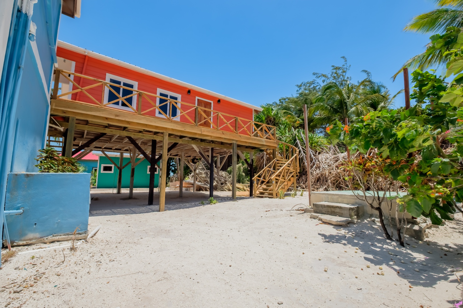 Orange Dolphin House on stilts with covered carport below