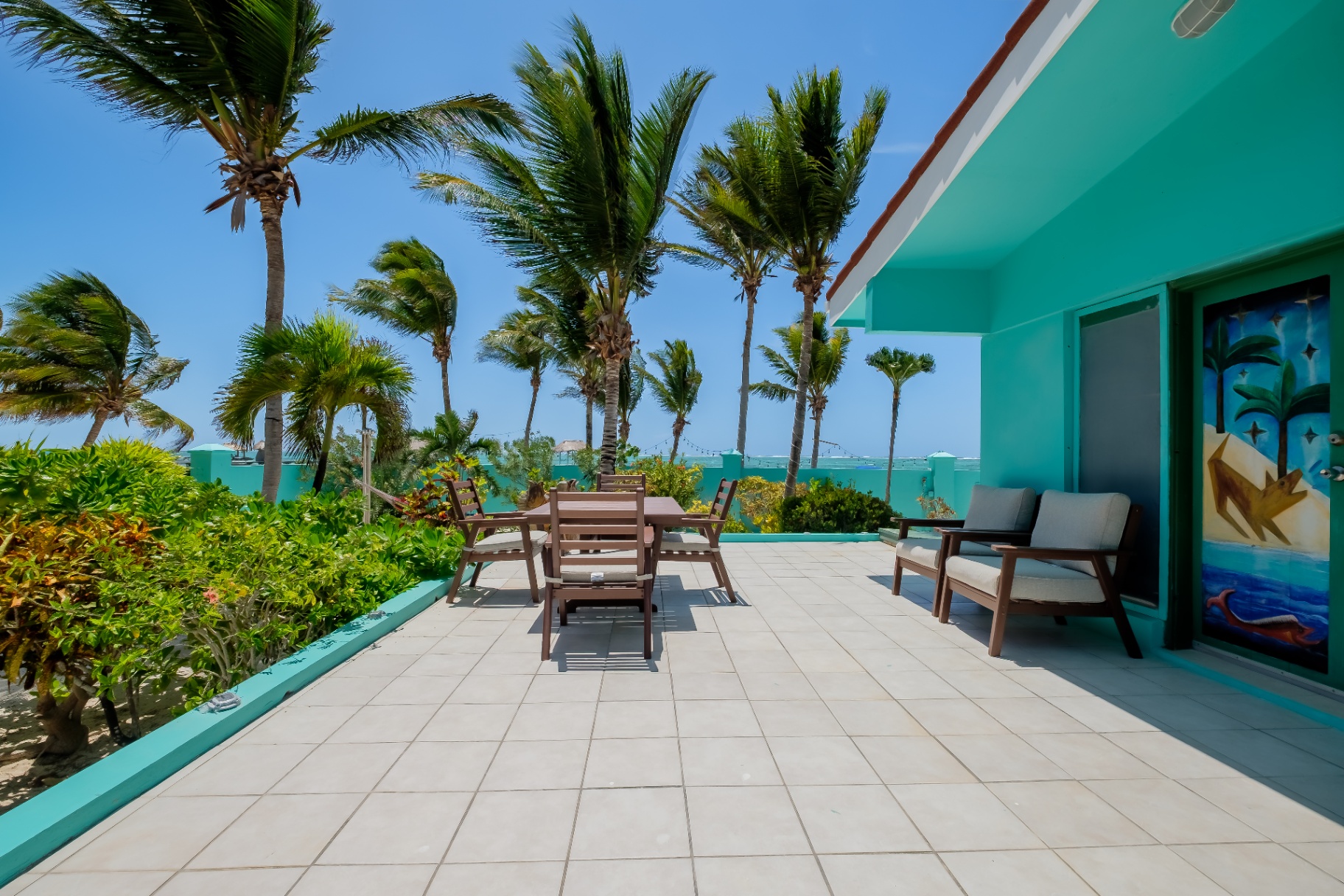 Oceanfront patio with palms and reef view
