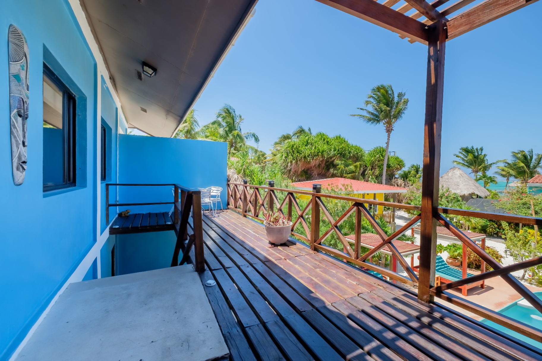 Upper balcony with sea views and tropical mask art