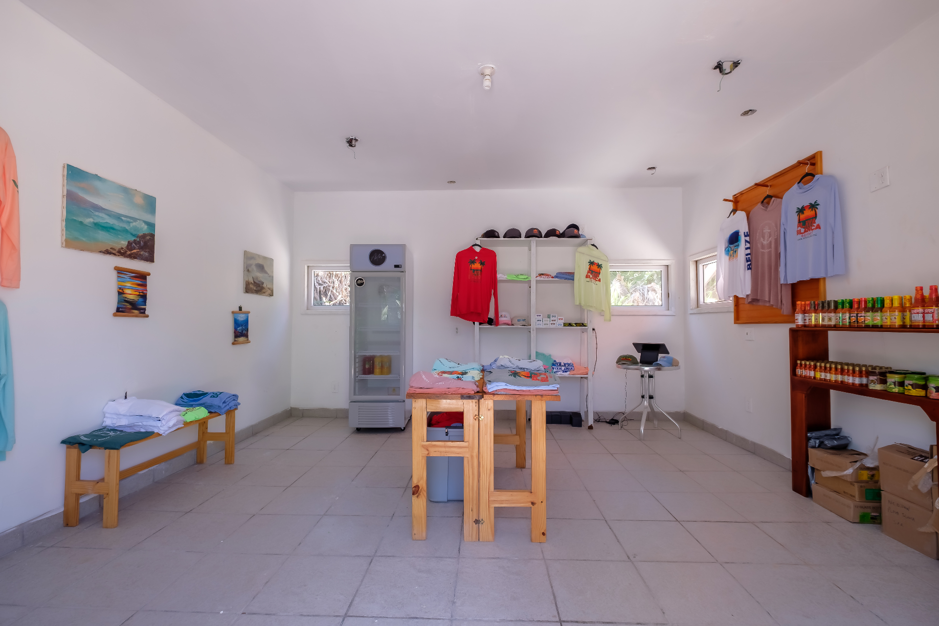 Wide view of the Playa Blanca gift shop with local paintings, cooler, and souvenirs