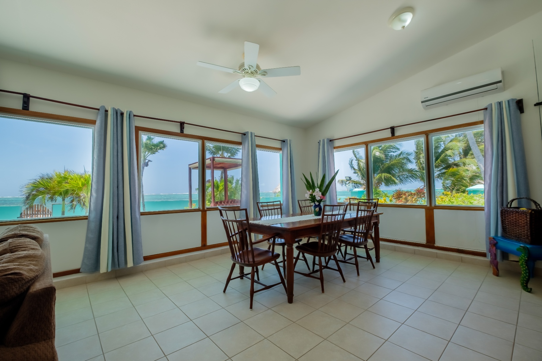 Dining area with vaulted ceiling and ocean view